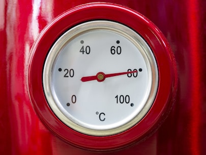 a close up of a thermometer on a red object