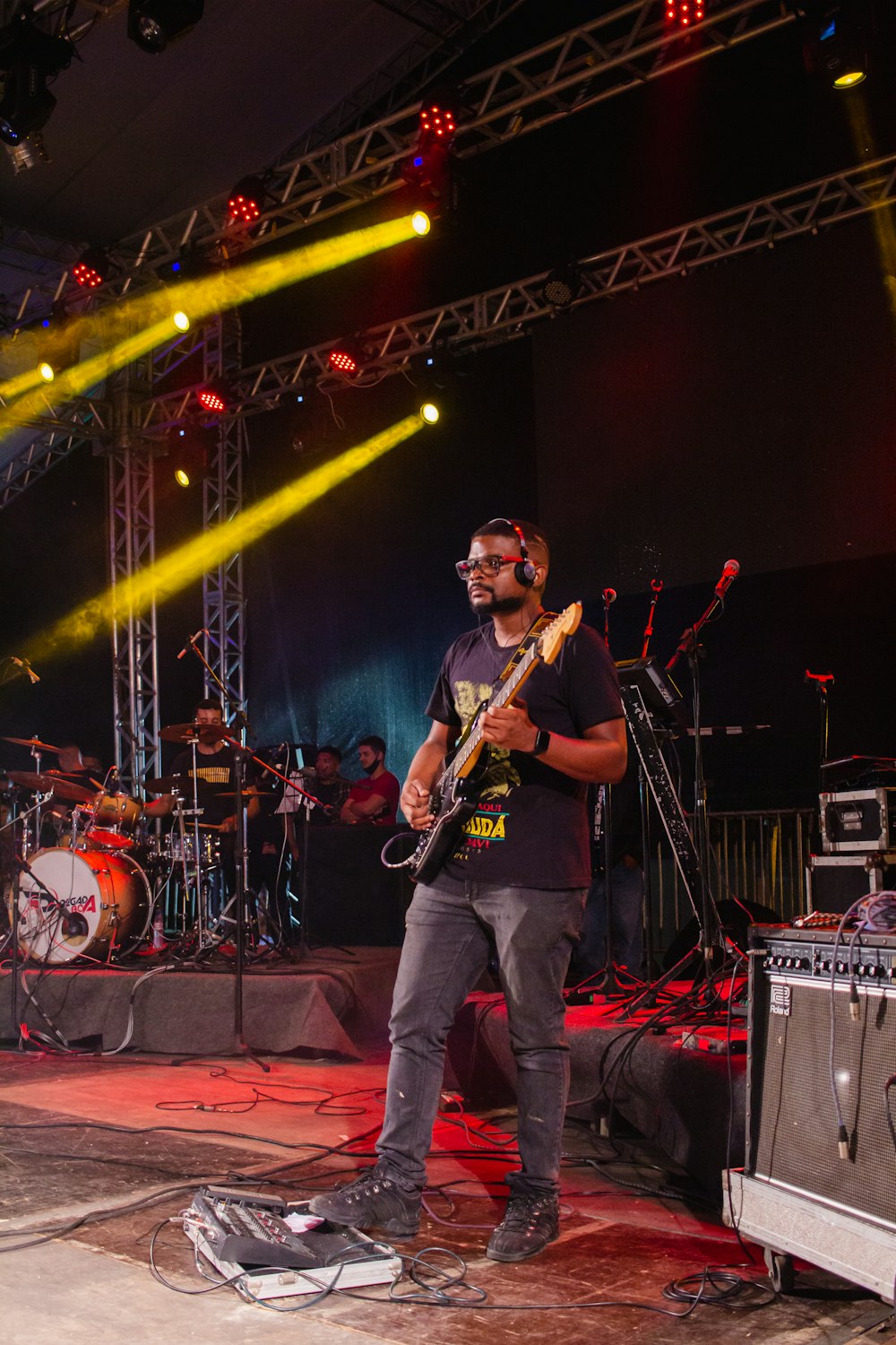 a man standing on a stage with a guitar