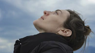 a woman looking up into the sky with her eyes closed