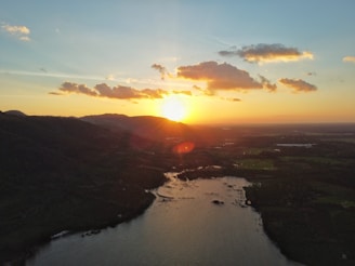 A breathtaking landscape showcasing a vibrant sunset over a serene lake.