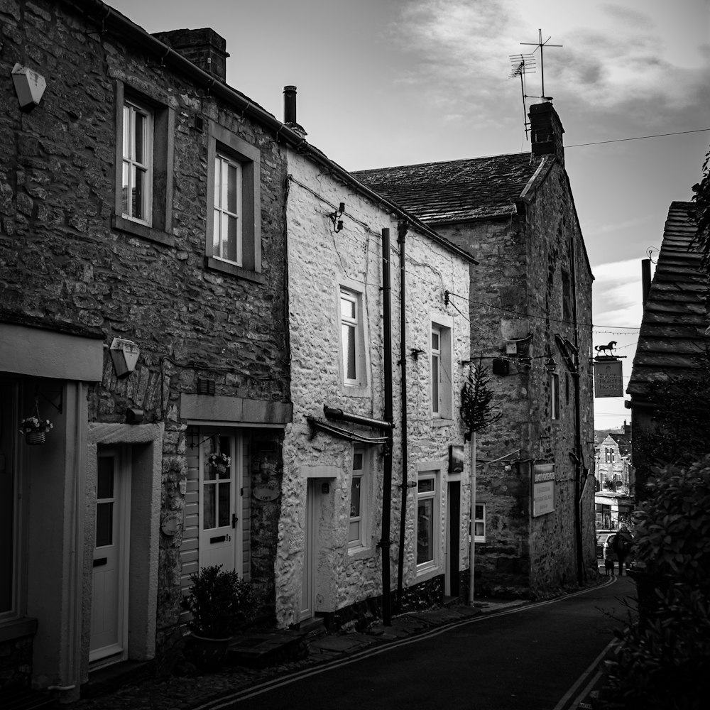 a black and white photo of a narrow street