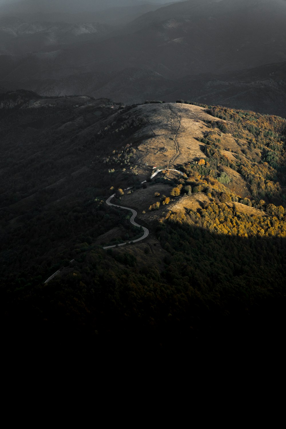 a scenic view of a winding road in the mountains