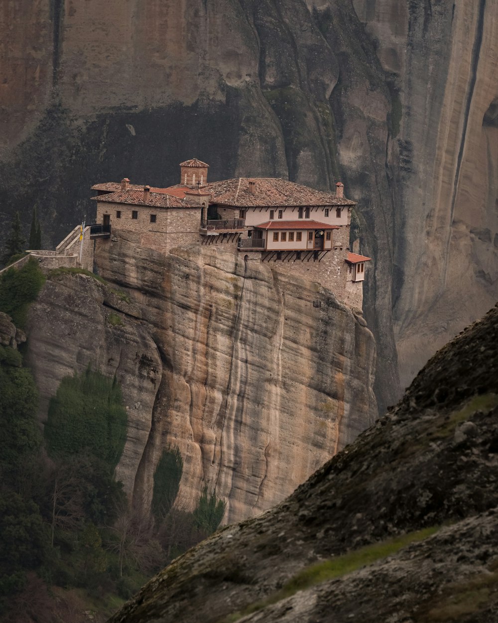 a cliff with a building on top of it