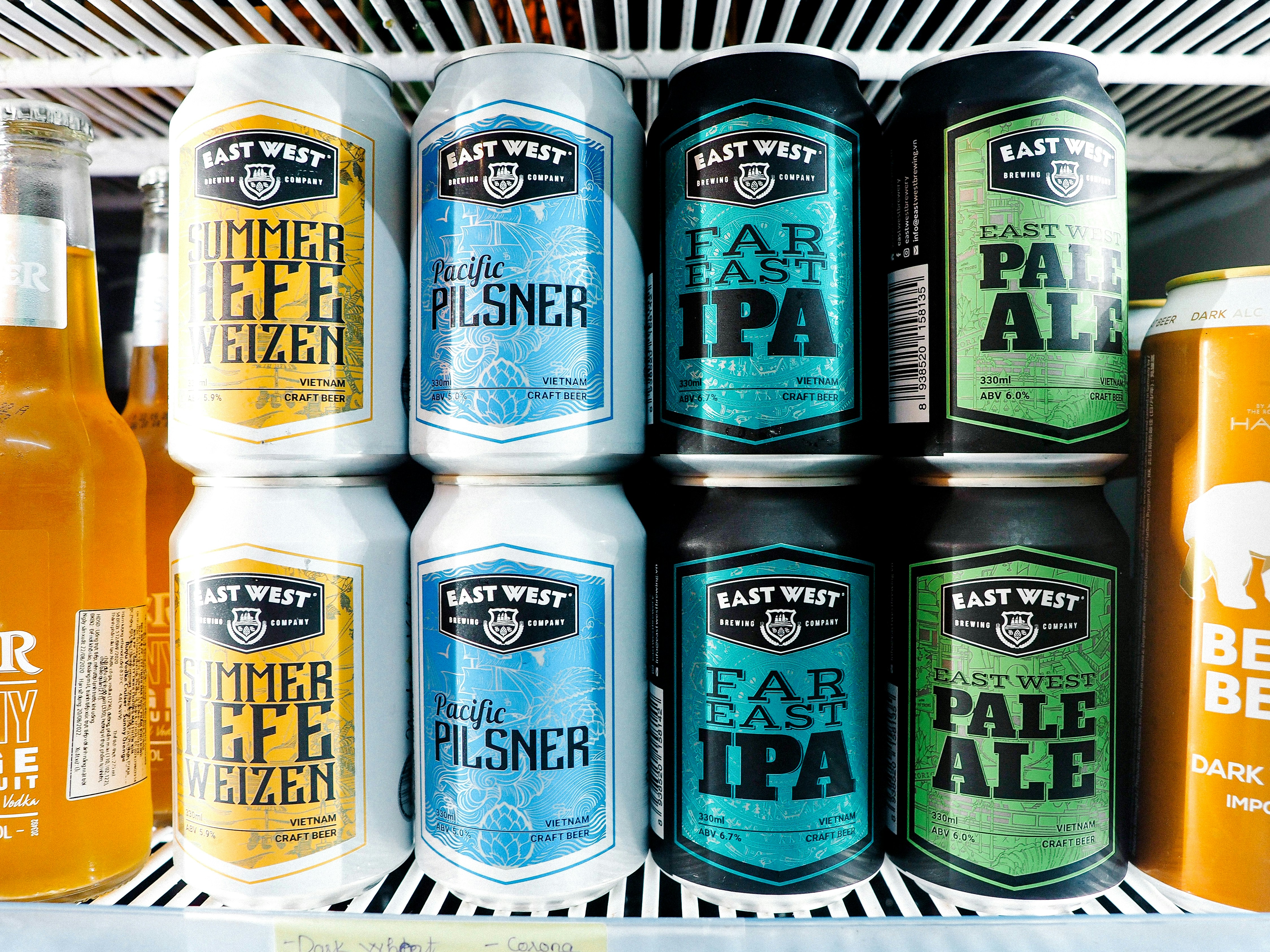 a refrigerator filled with lots of different types of beer