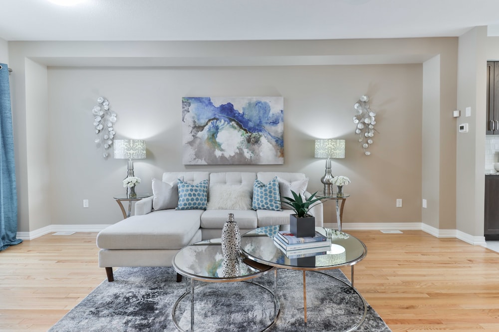 a living room filled with furniture and a painting on the wall