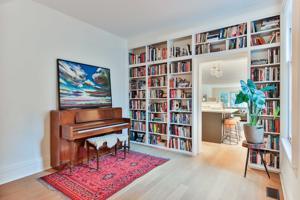 a living room filled with lots of books and furniture