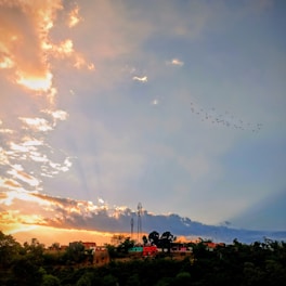 A scenic view of a Minecraft village at sunset with players interacting.