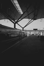 a black and white photo of a train at a train station