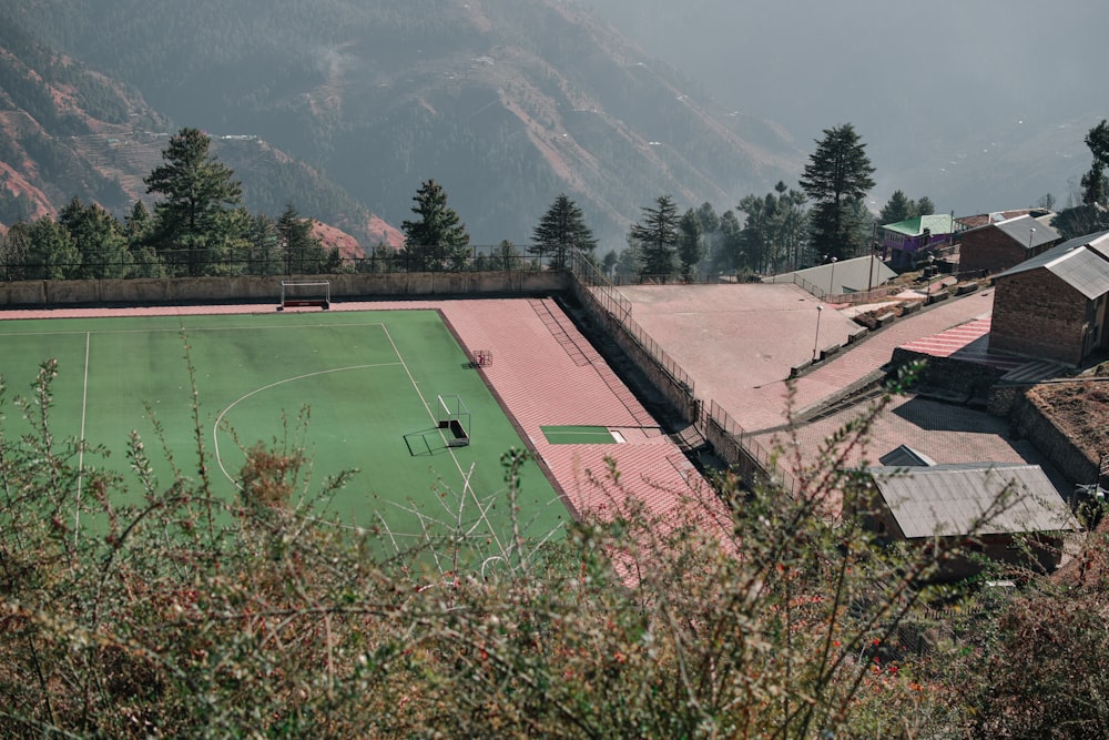 a soccer field surrounded by mountains and trees