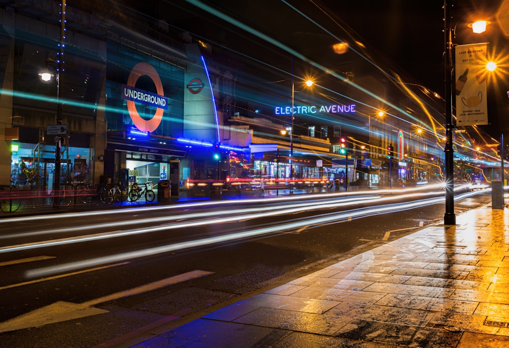 a city street at night with lights streaking by