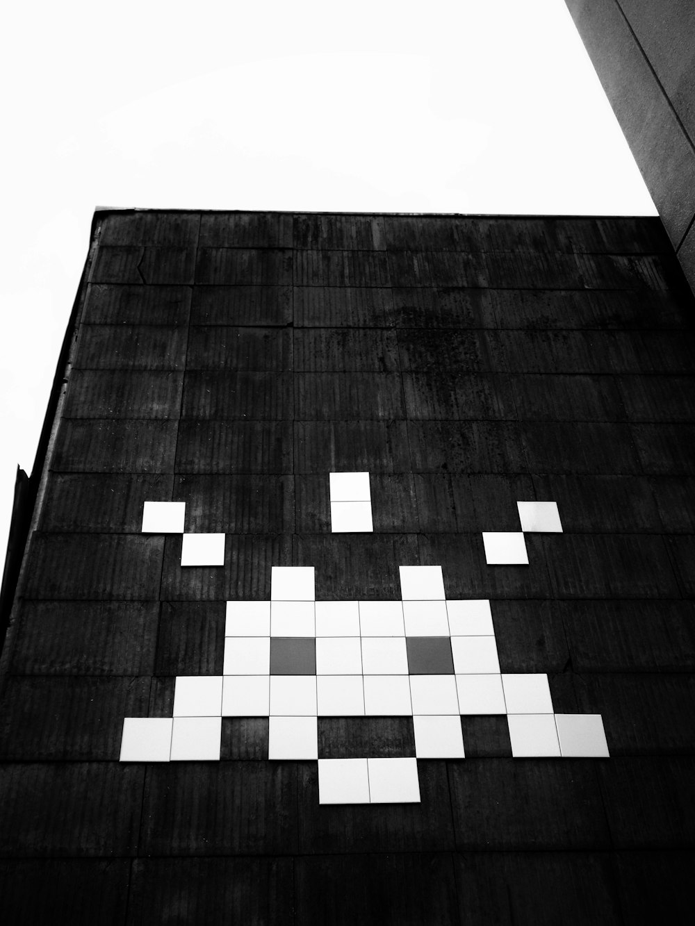 a black and white photo of a building with squares painted on it