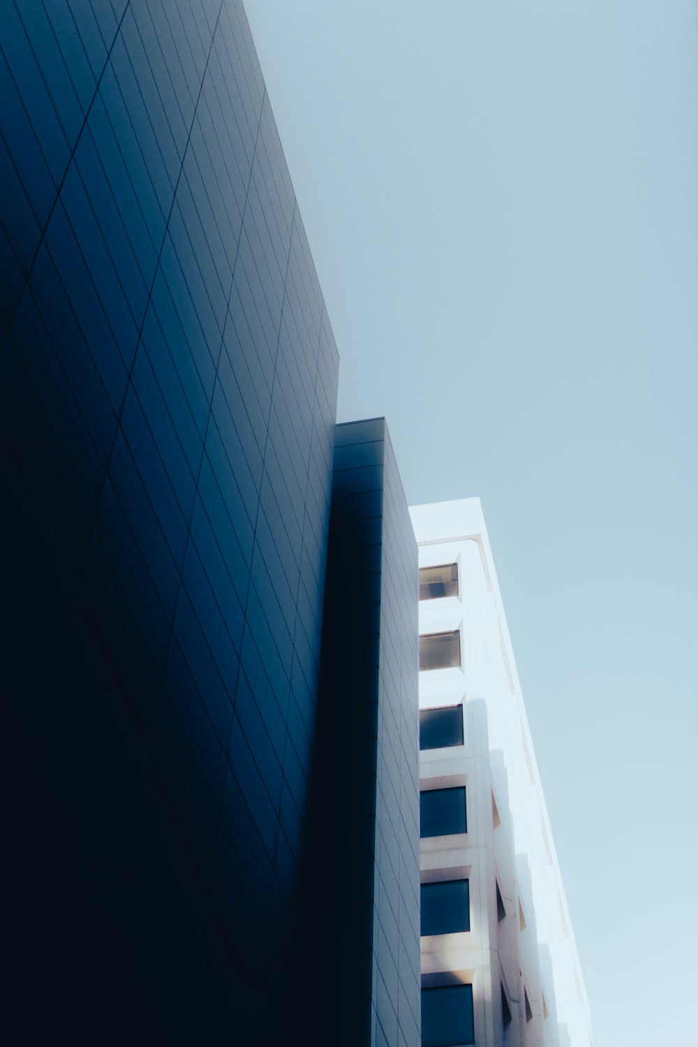 a tall white building with a sky background