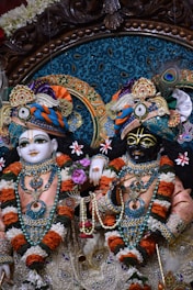 a couple of statues of deities in a room
