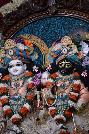 a couple of statues of deities in a room