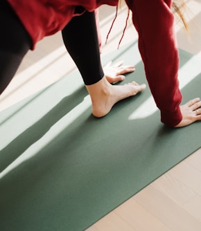 a person standing on a yoga mat on the floor