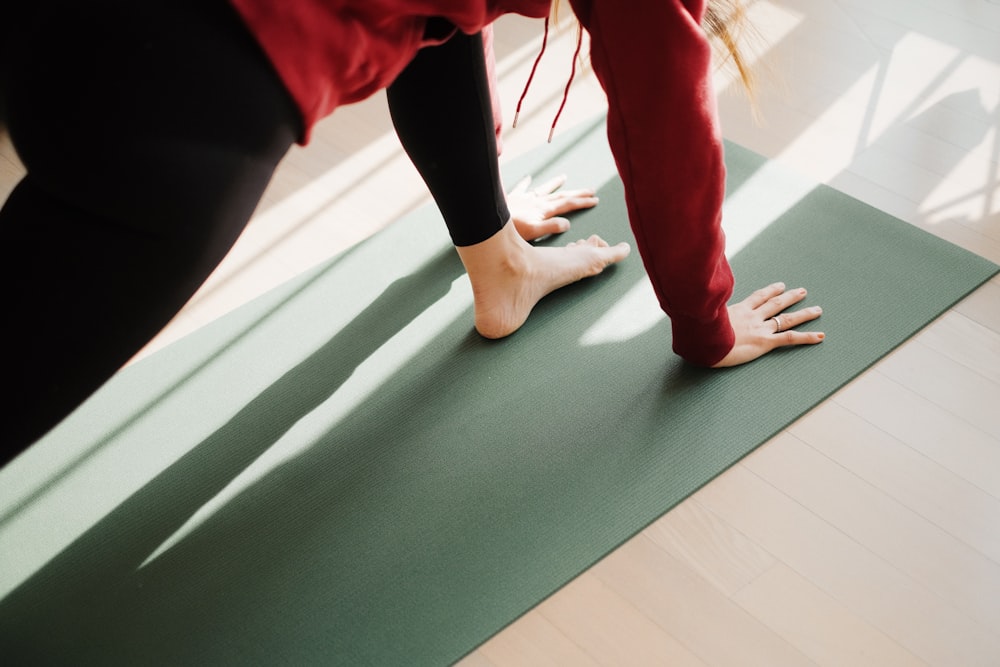 a person standing on a yoga mat on the floor