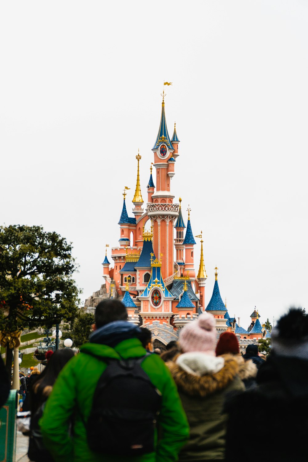 a group of people standing in front of a castle