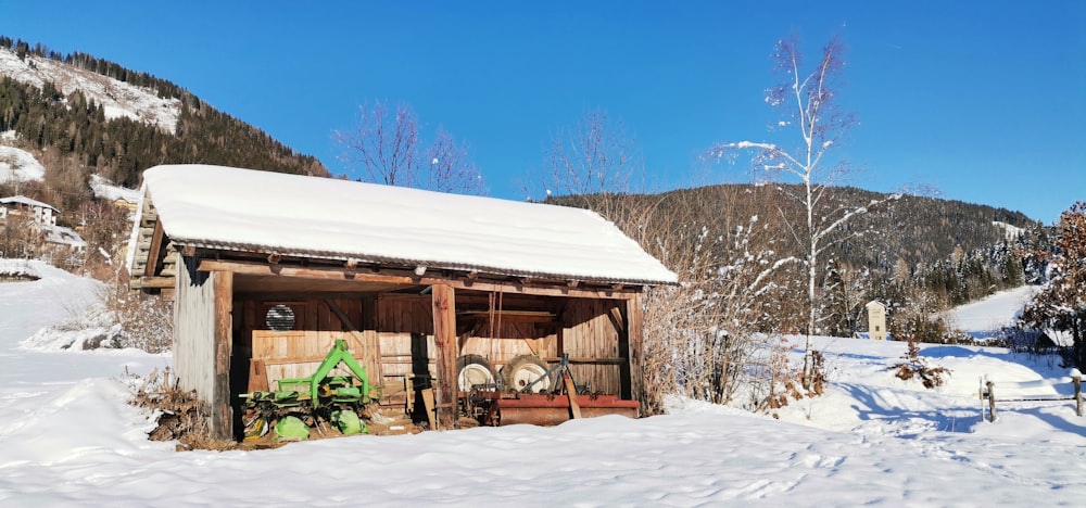 a small building with a snow covered roof