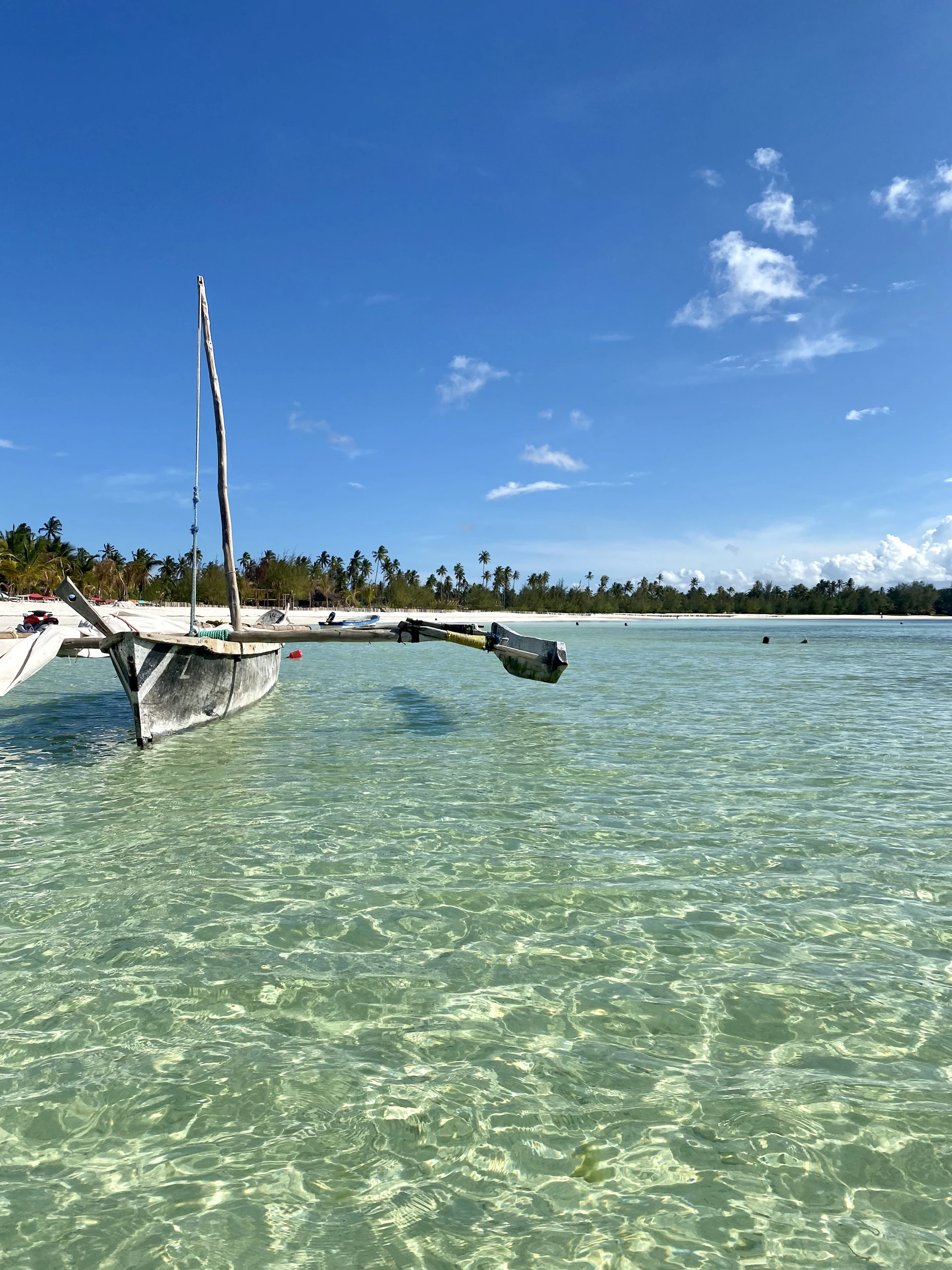Traditional wooden boats bobbing gently on the crystal-clear waters of Tunku Abdul Rahman Marine Park.