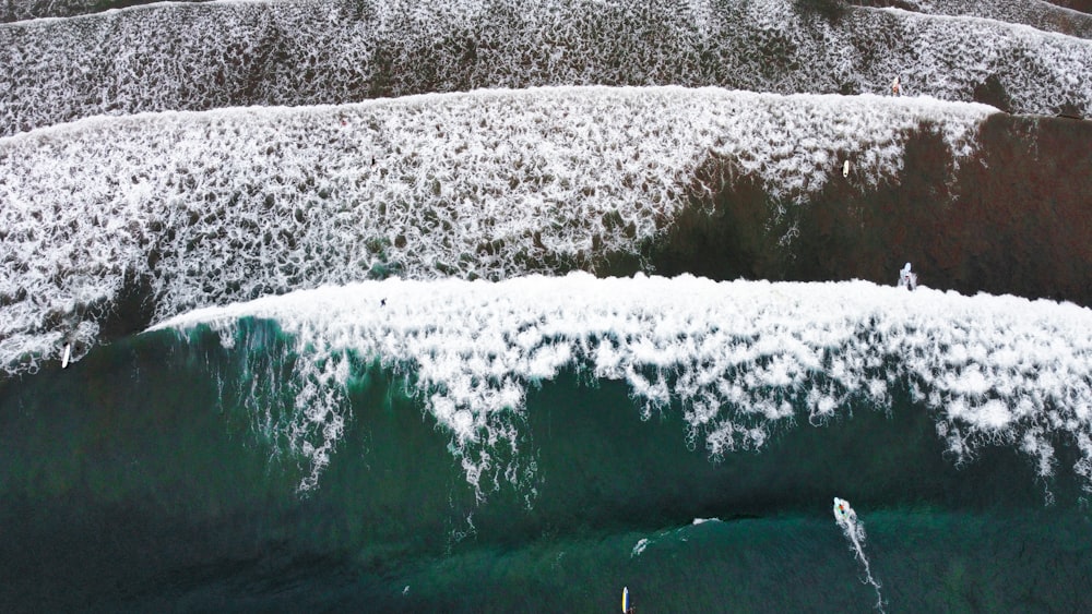 an aerial view of a body of water surrounded by snow