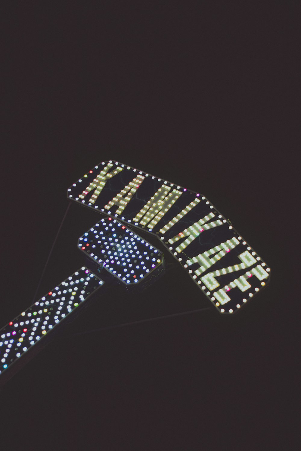a close up of a lit up sign in the dark