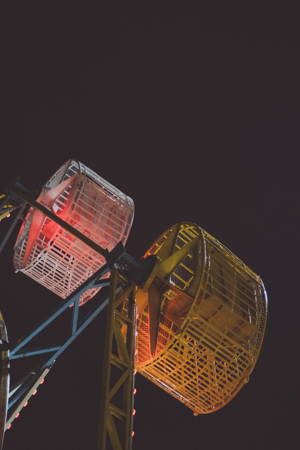 a ferris wheel lit up at night with red lights