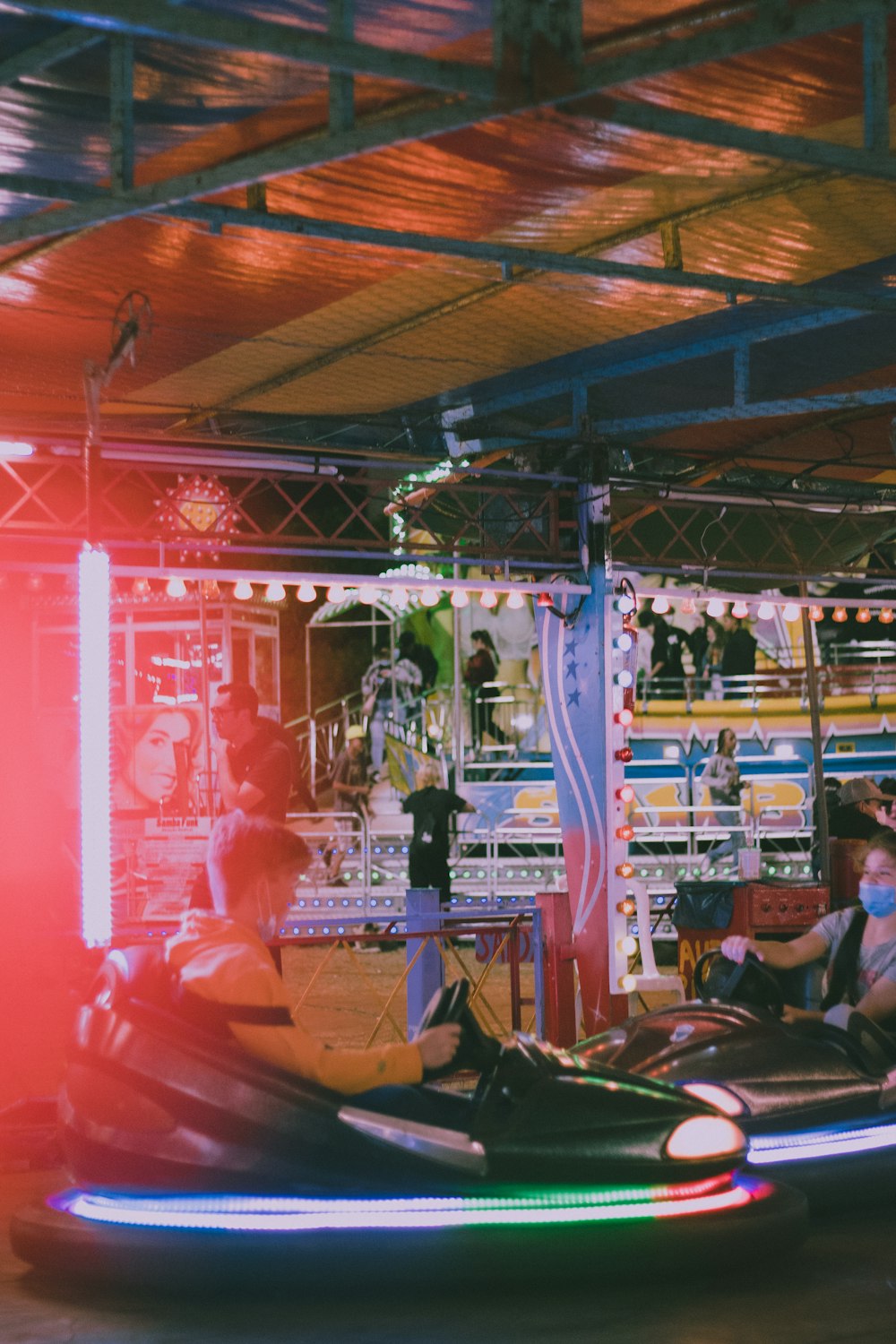 a group of people riding on top of bumper cars