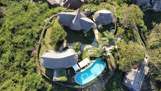 an aerial view of a house with a pool