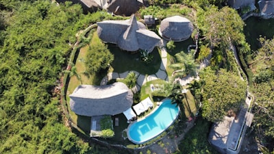 an aerial view of a house with a pool