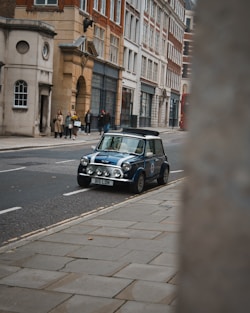 a mini car is parked on the side of the road