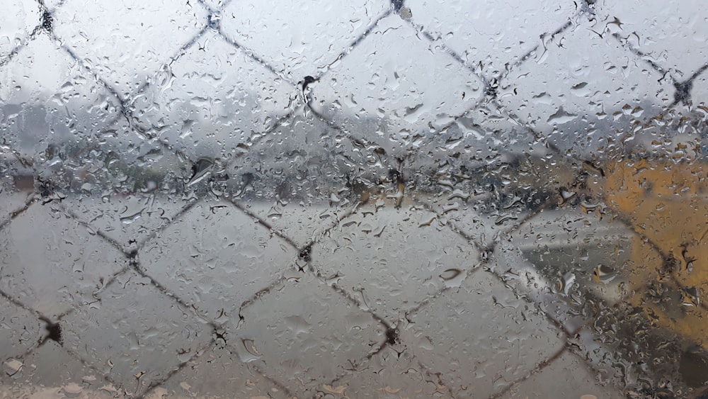 a view of a body of water through a chain link fence