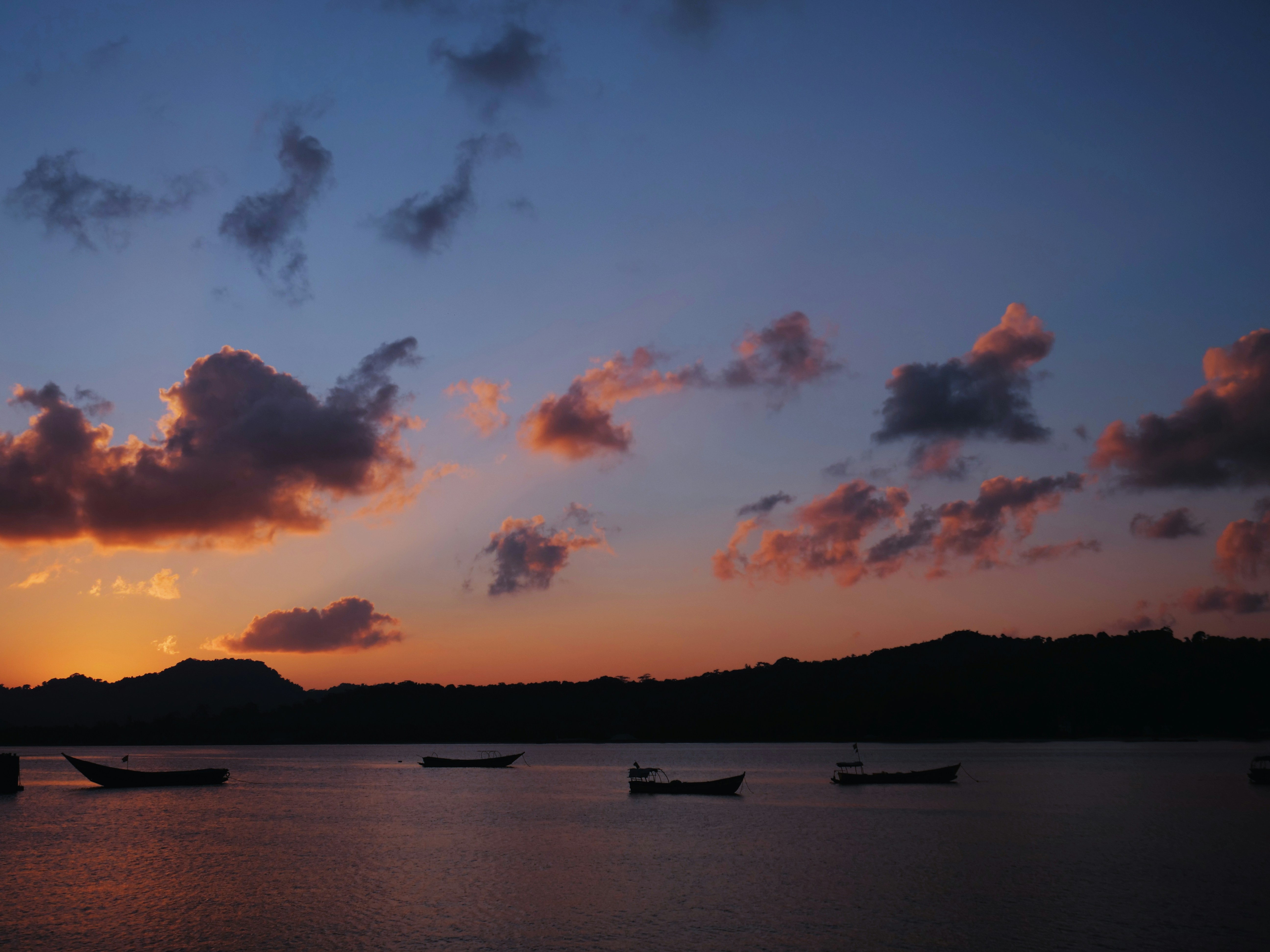 a group of boats floating on top of a lake, 