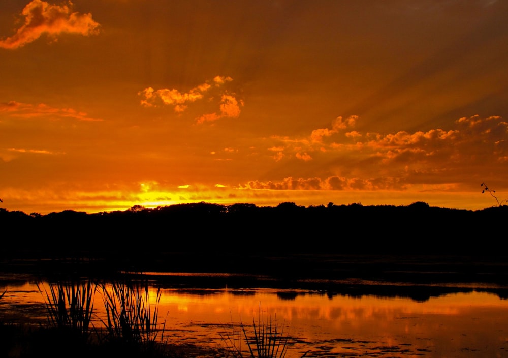 the sun is setting over a body of water