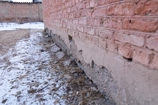 a brick wall that has been damaged by water flooding