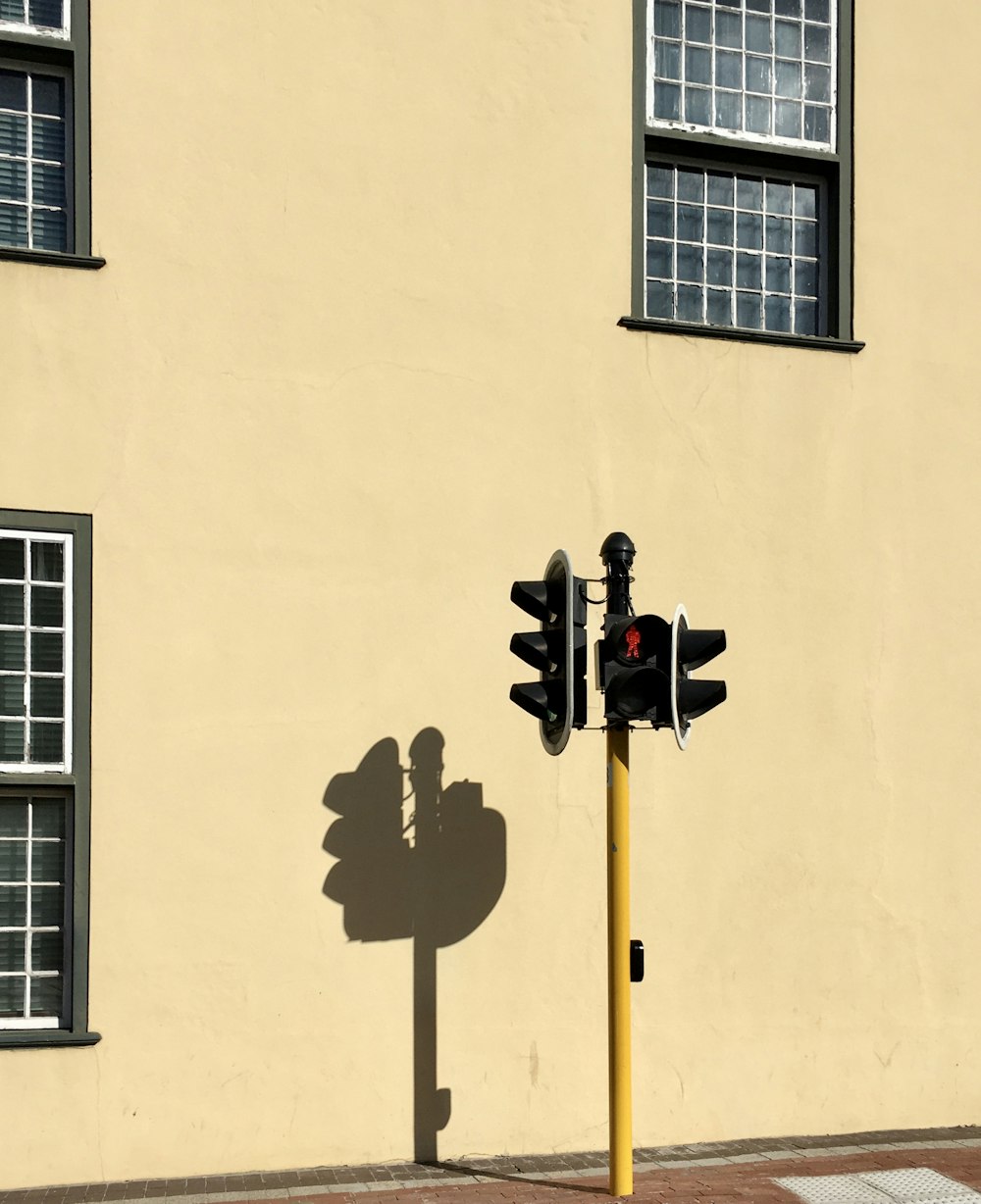 a shadow of a traffic light on a street