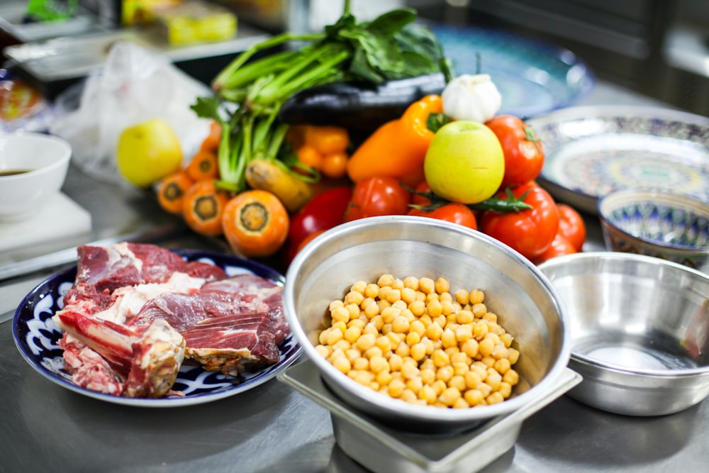 a table topped with bowls of food and bowls of meat