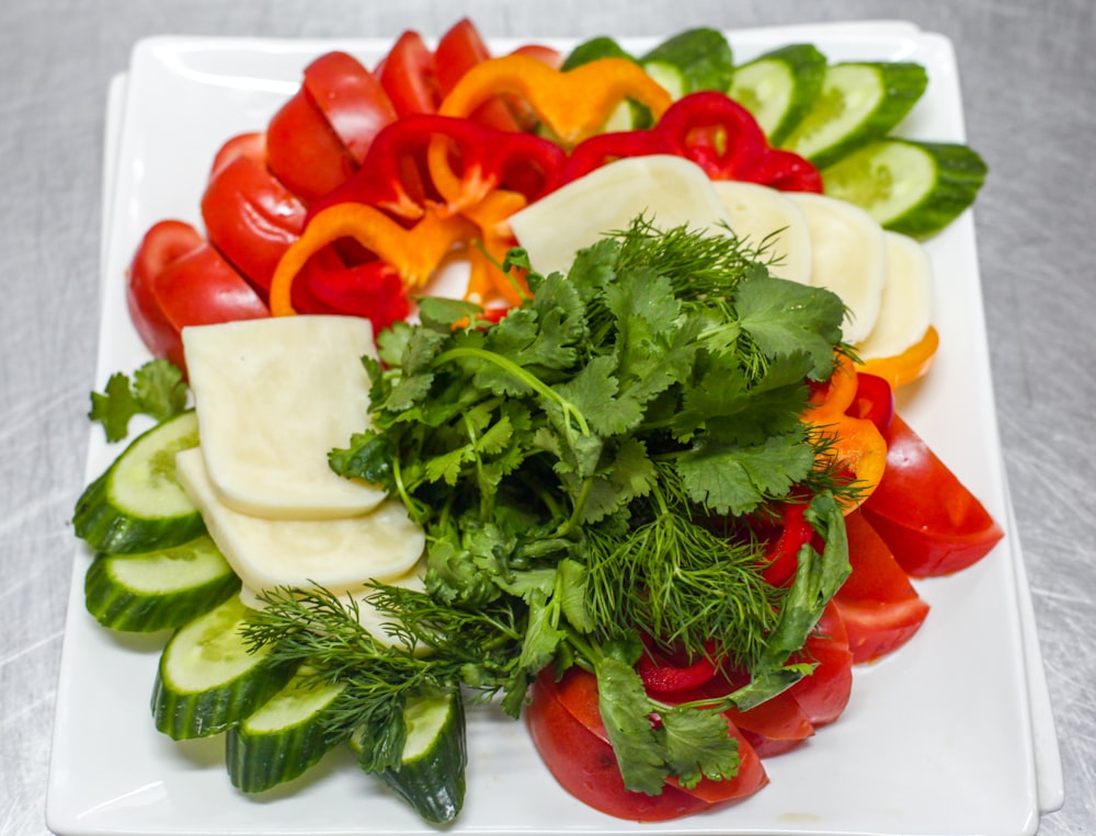 a white plate topped with sliced up veggies