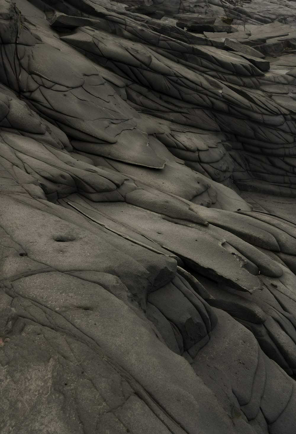 a black and white photo of rocks and water