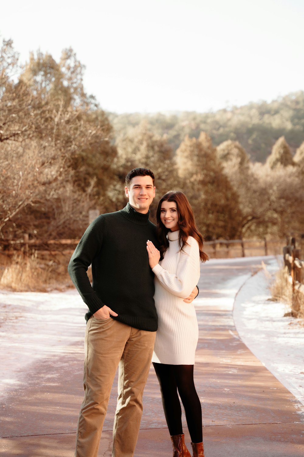 a man and woman posing for a picture in the snow