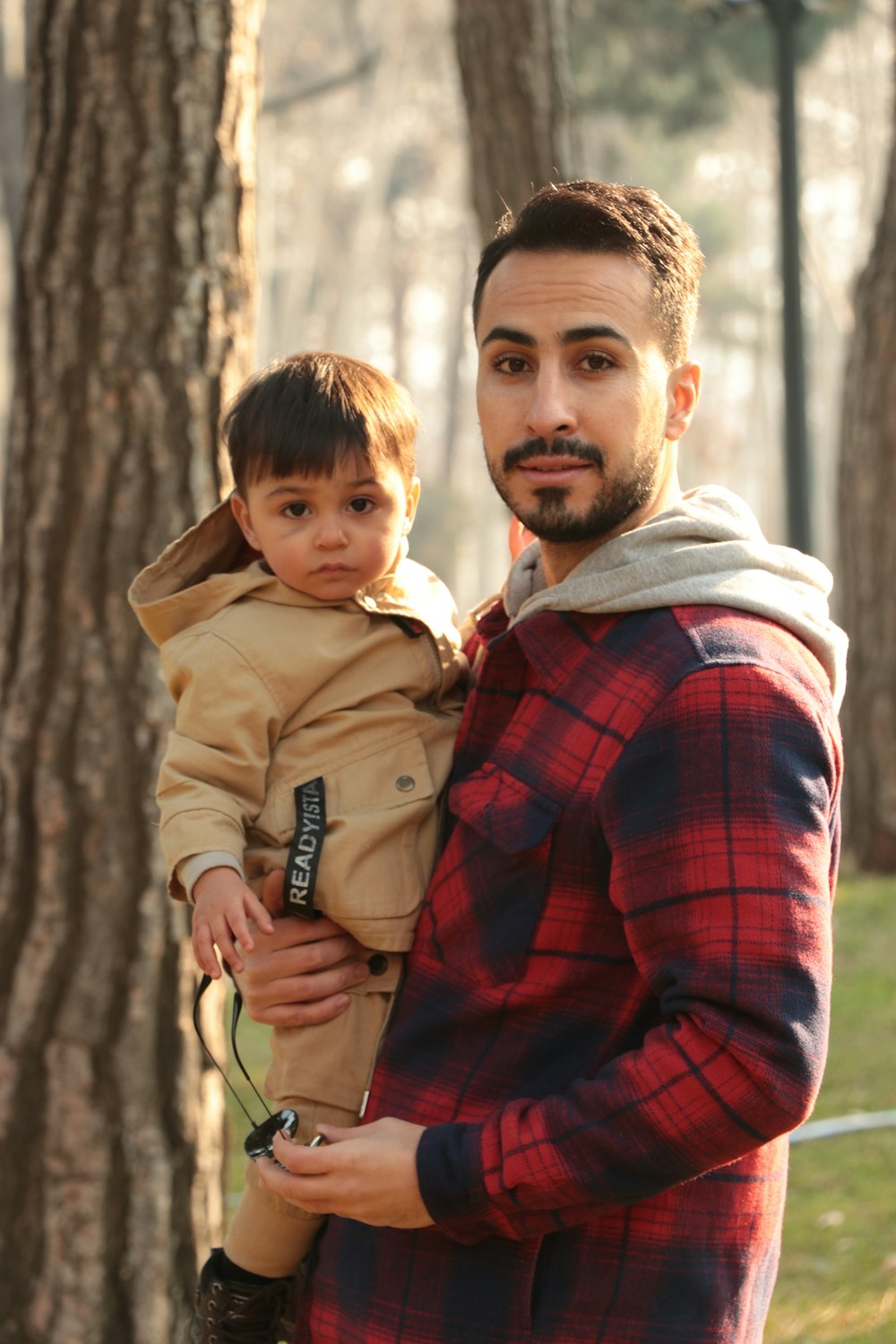 a man holding a small boy in his arms