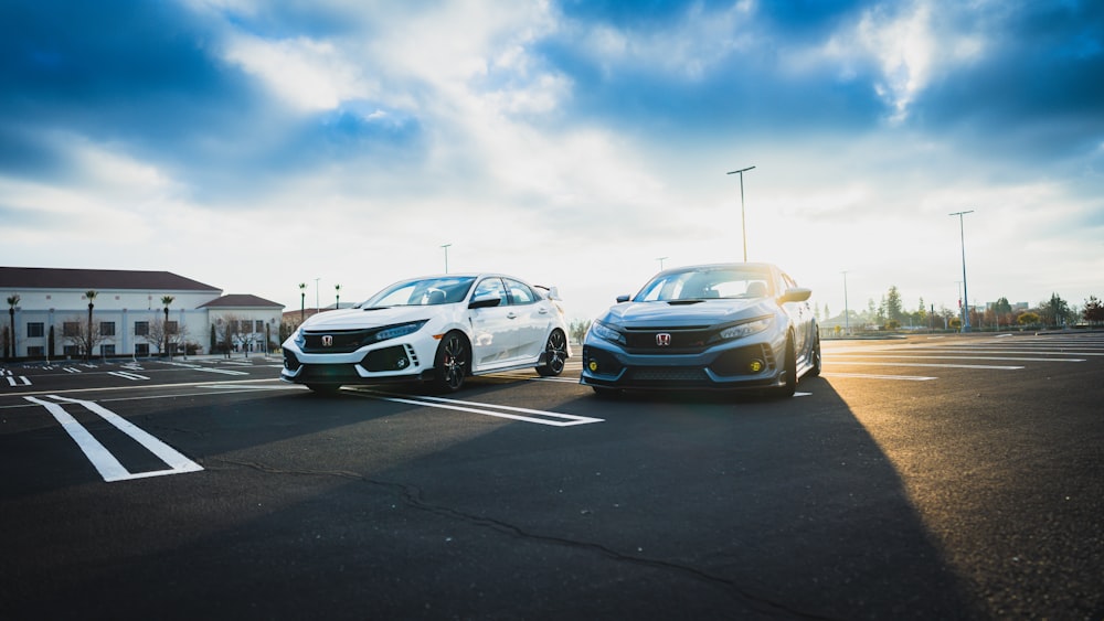 two cars parked in a parking lot next to each other