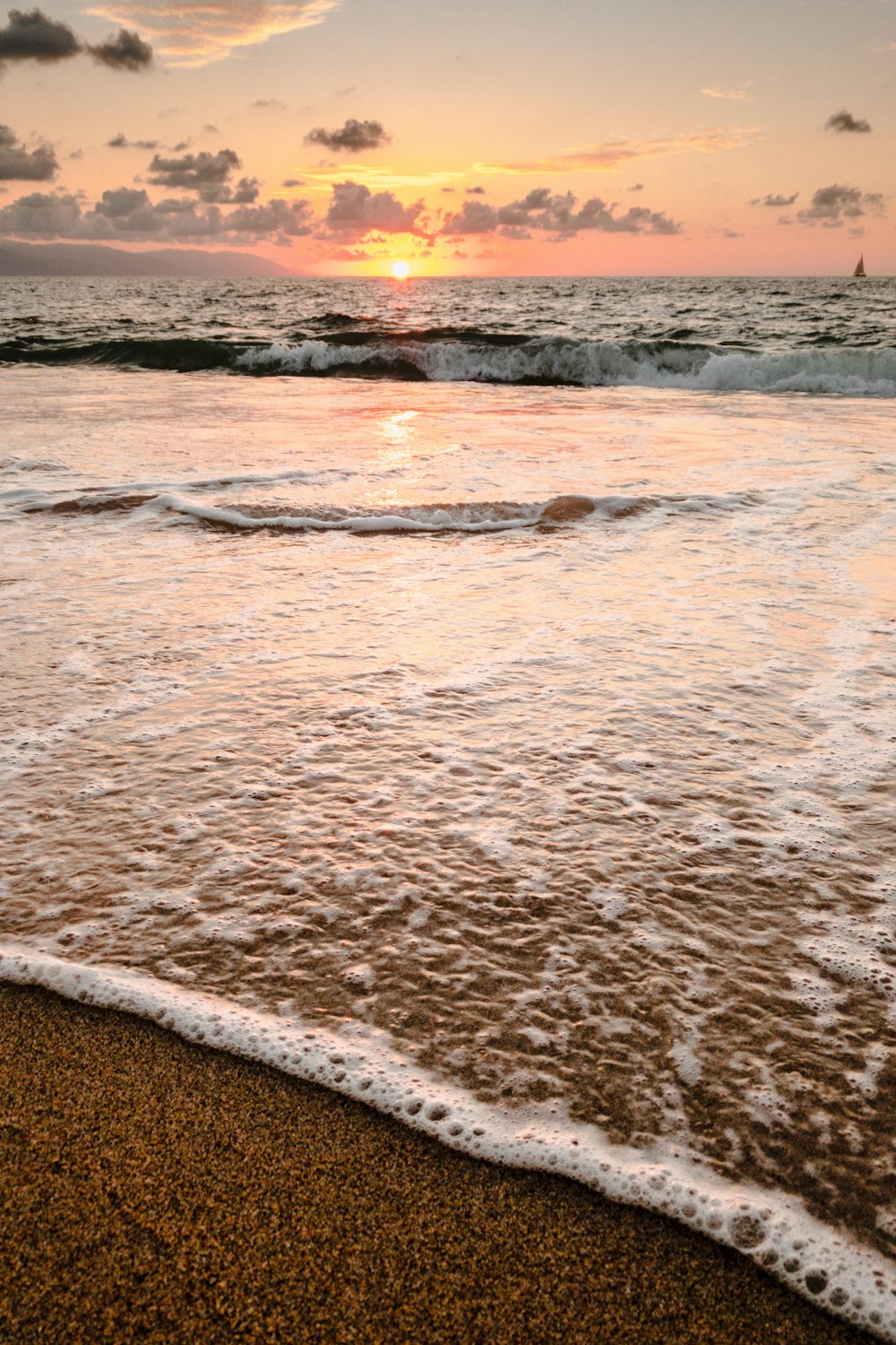 a sandy beach next to the water