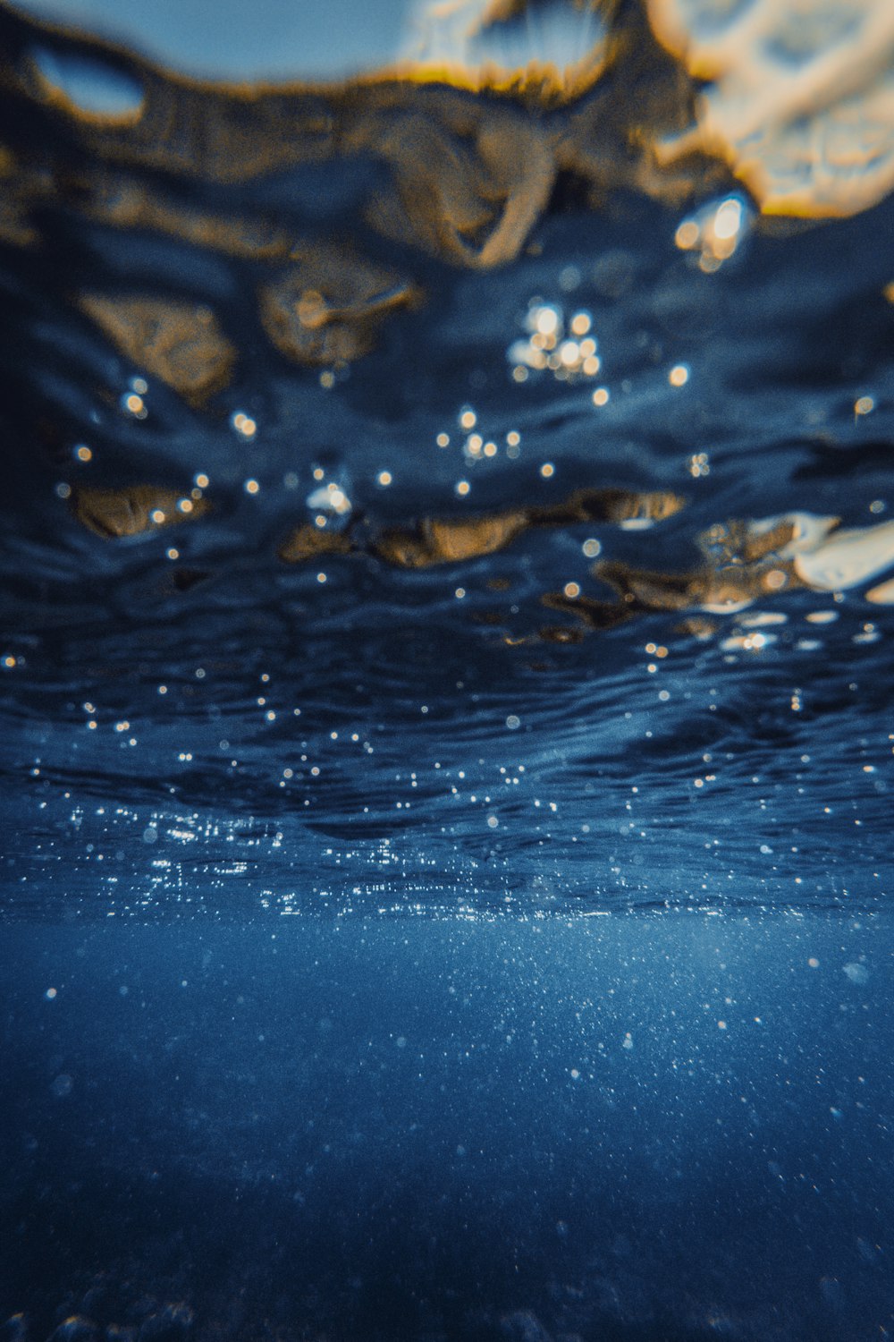 an underwater view of the water surface with bubbles