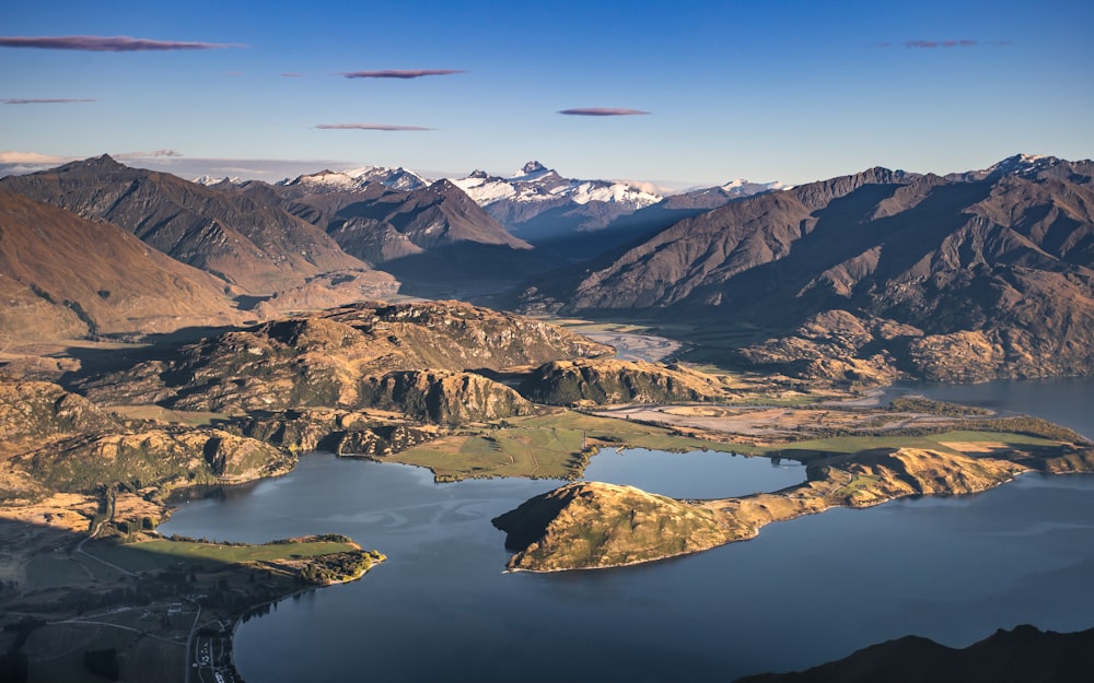 an aerial view of a lake surrounded by mountains