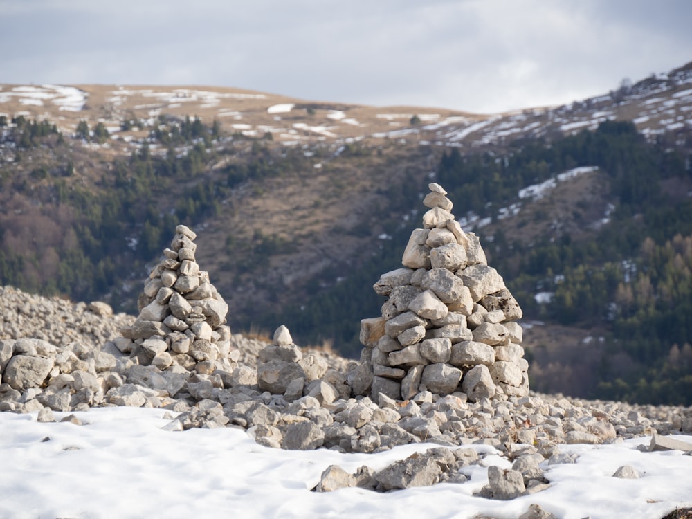 a pile of rocks sitting on top of a snow covered ground