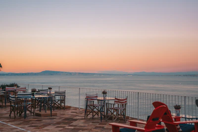 An outdoor terrace bathed in sunset light, with comfortable chairs and a view of Pandharpur’s temple spires.