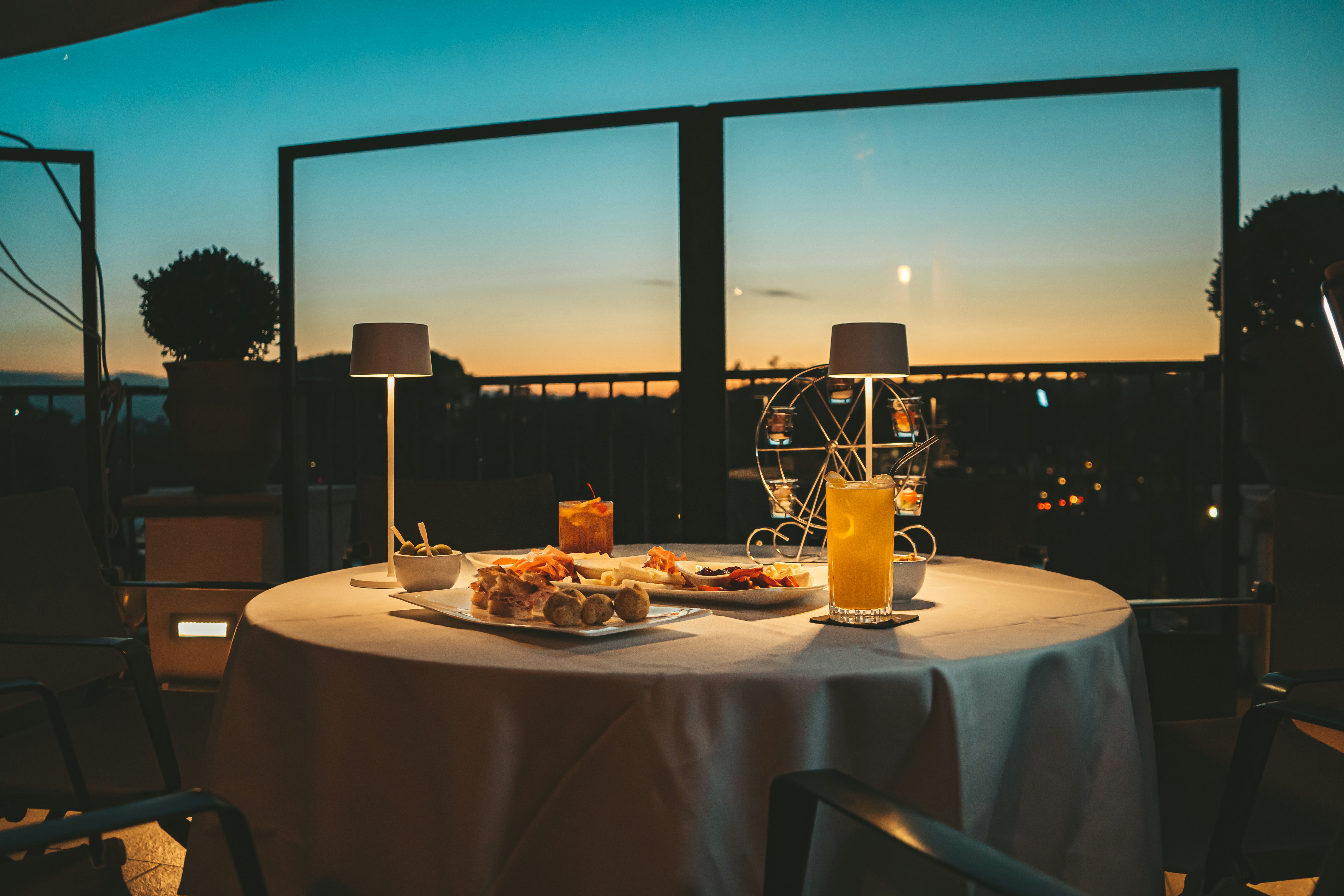 a table with a plate of food and a glass of orange juice