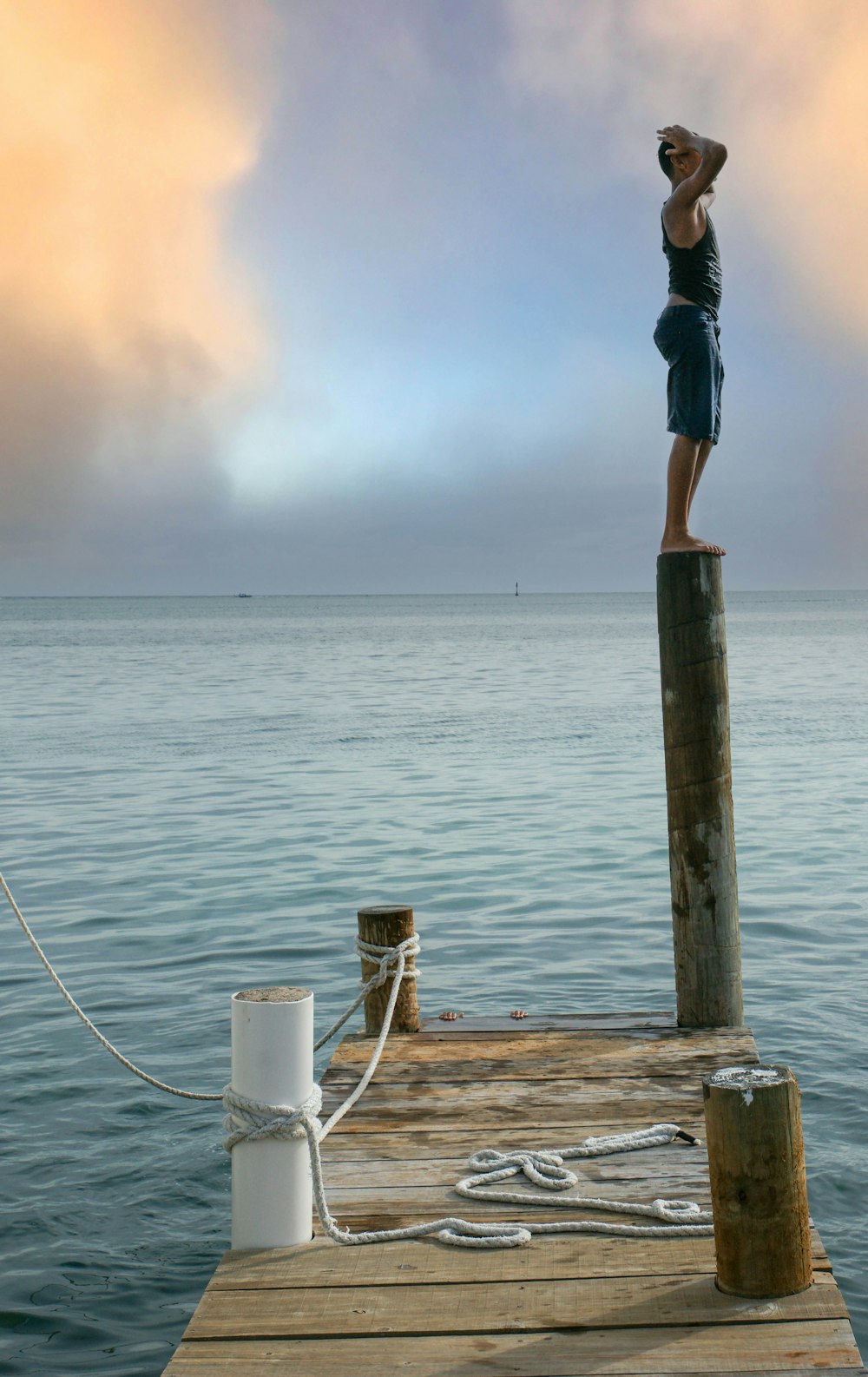 a person standing on a dock with a hat on