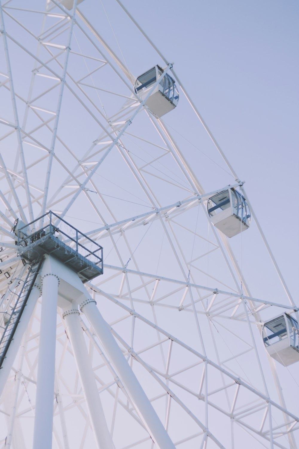 a large white ferris wheel on a clear day