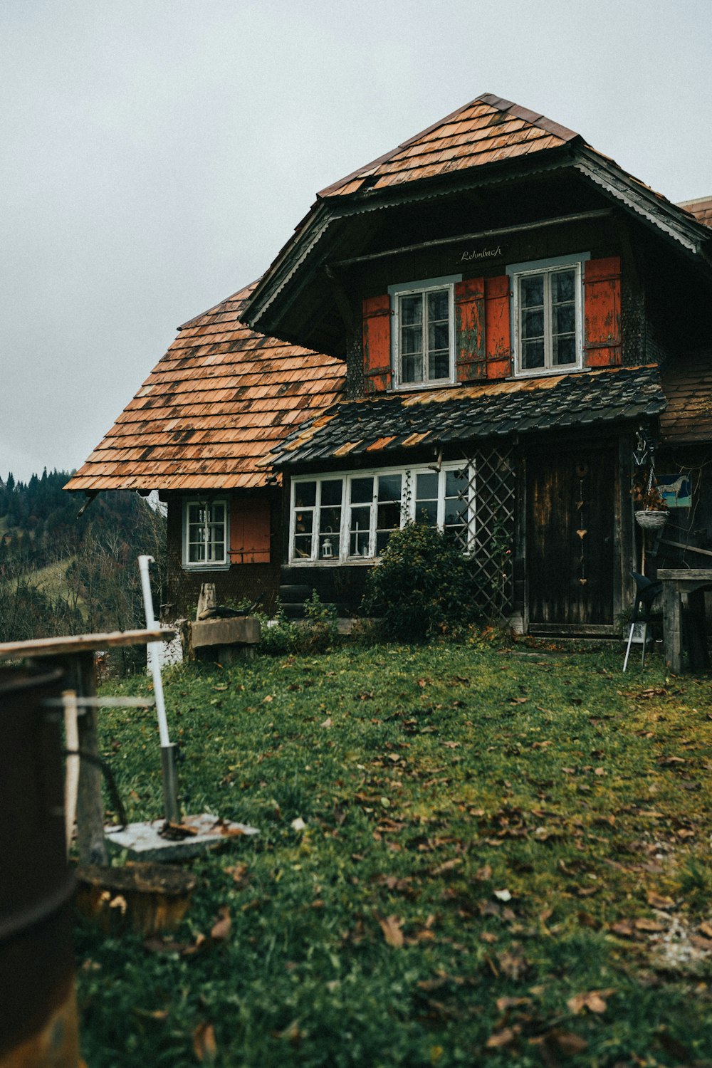 an old wooden house with a red roof